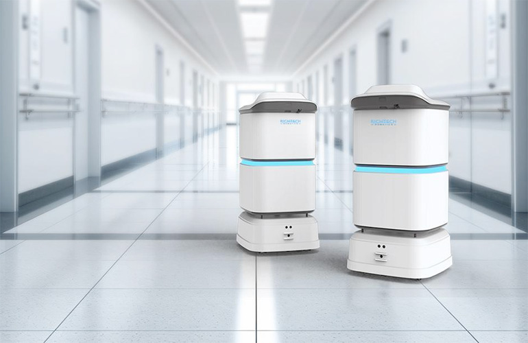 two medbot mobile robots in a hospital hallway.