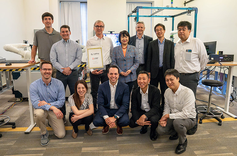 Members of Realtime Robotics and Mitsubishi Electric's teams celebrate their partnership.